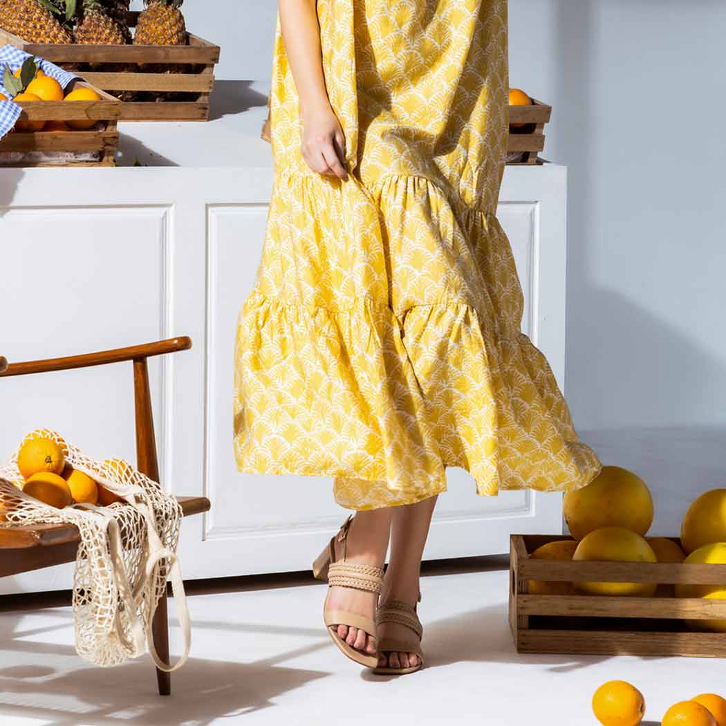 Saint Valeria nude woven low block heel sandals worn with yellow outfit, lifestyle view