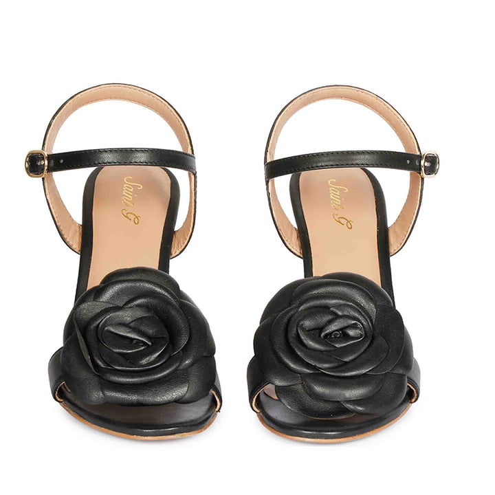 Saint Veronique black leather stilettos, front view of flower embellishment