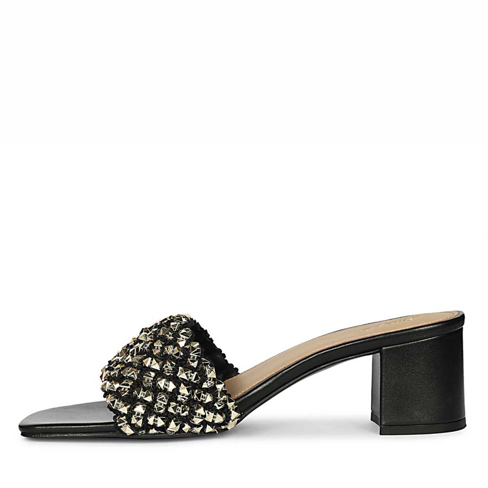 Black sandal with decorative element on a white background