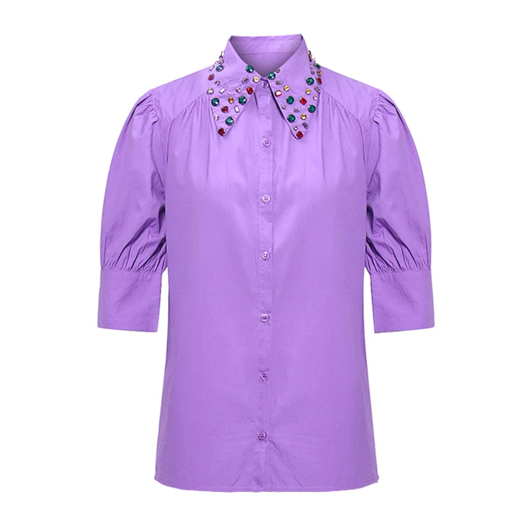 Close-up of jewelled embellishment on a purple shirt collar  for UK Women