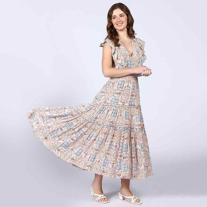 Woman wearing a beige printed maxi dress, skirt flowing.