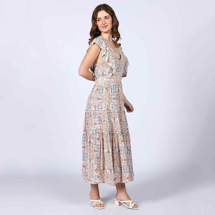 Woman wearing a beige multicolour printed maxi dress, walking.