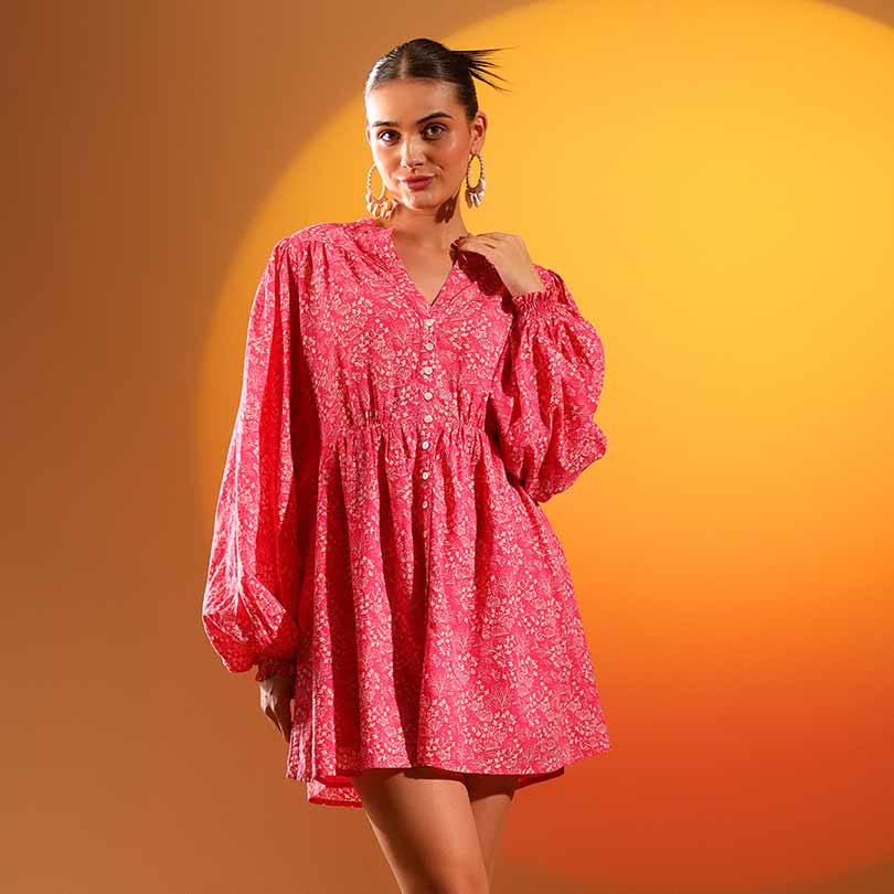 Side view of a woman wearing a coral printed short dress.