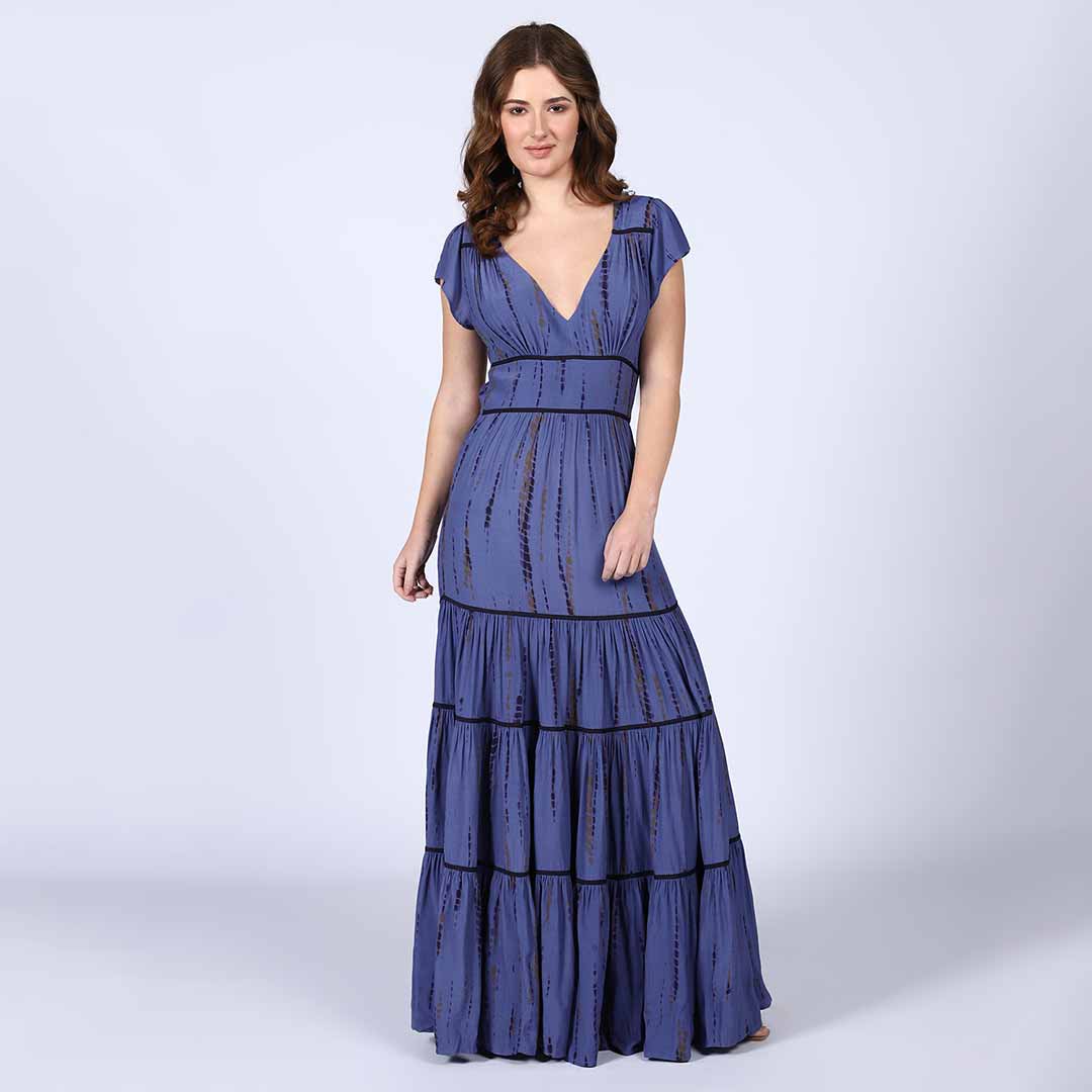 Woman wearing an indigo tie-dye-print tiered viscose maxi dress with a V-neck.