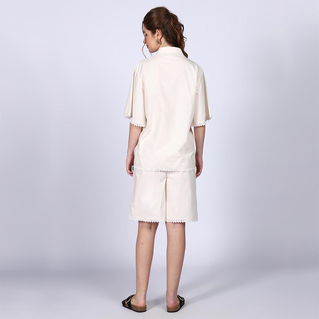 Back view of a woman wearing an ivory cotton poplin co-ord set.