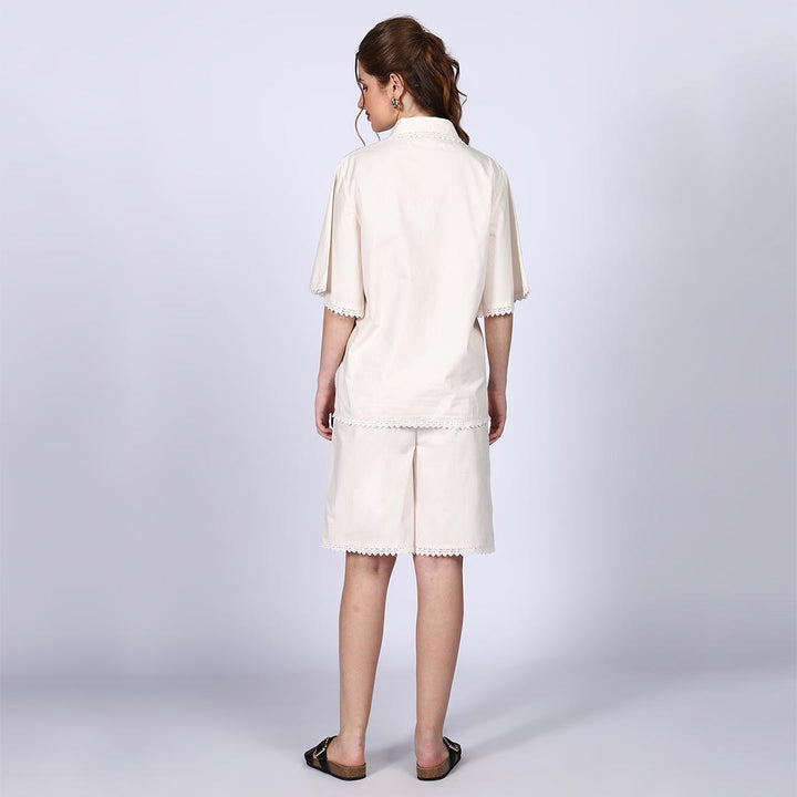 Back view of a woman wearing an ivory cotton poplin co-ord set.