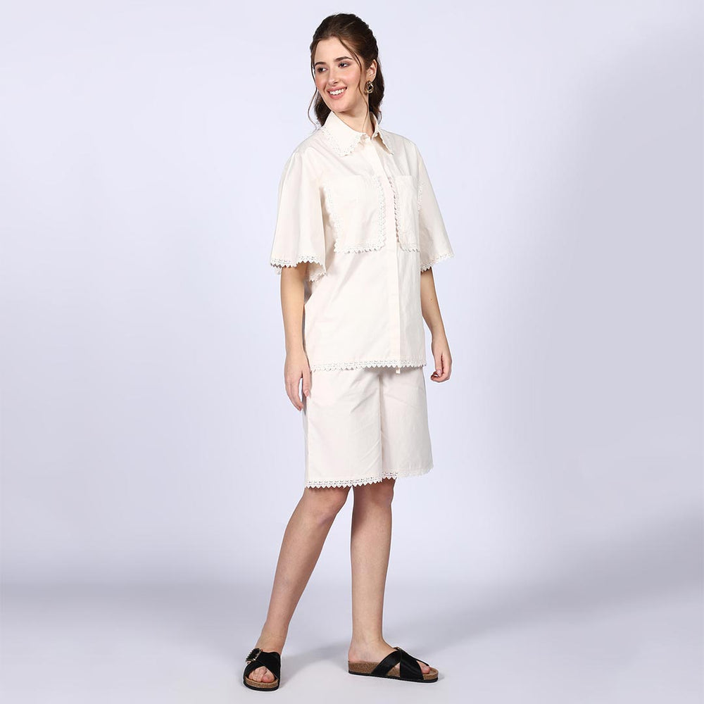 Side view of a woman wearing an ivory cotton co-ord set.