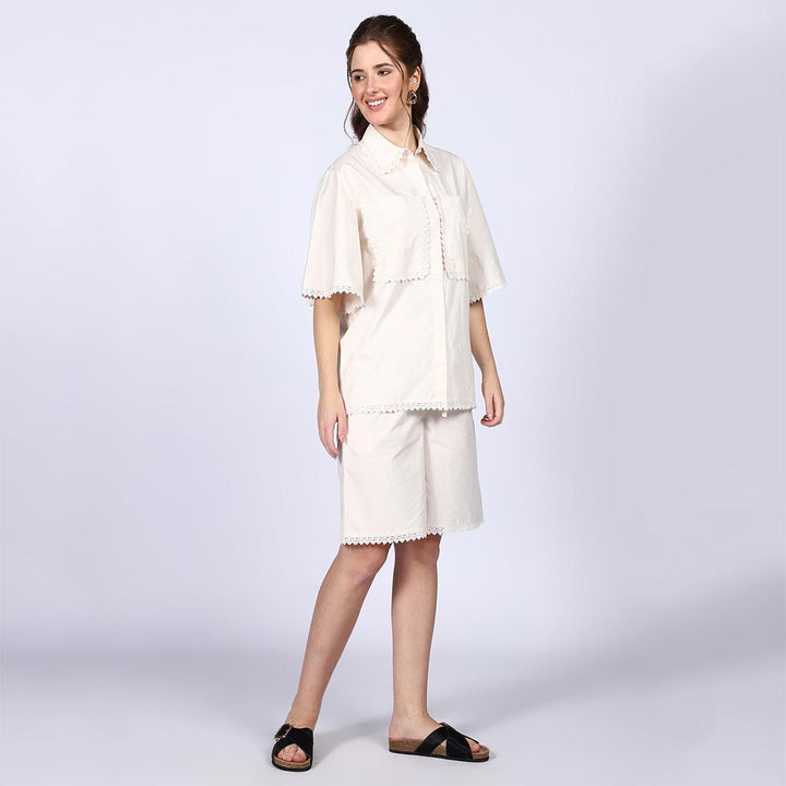 Side view of a woman wearing an ivory cotton co-ord set.