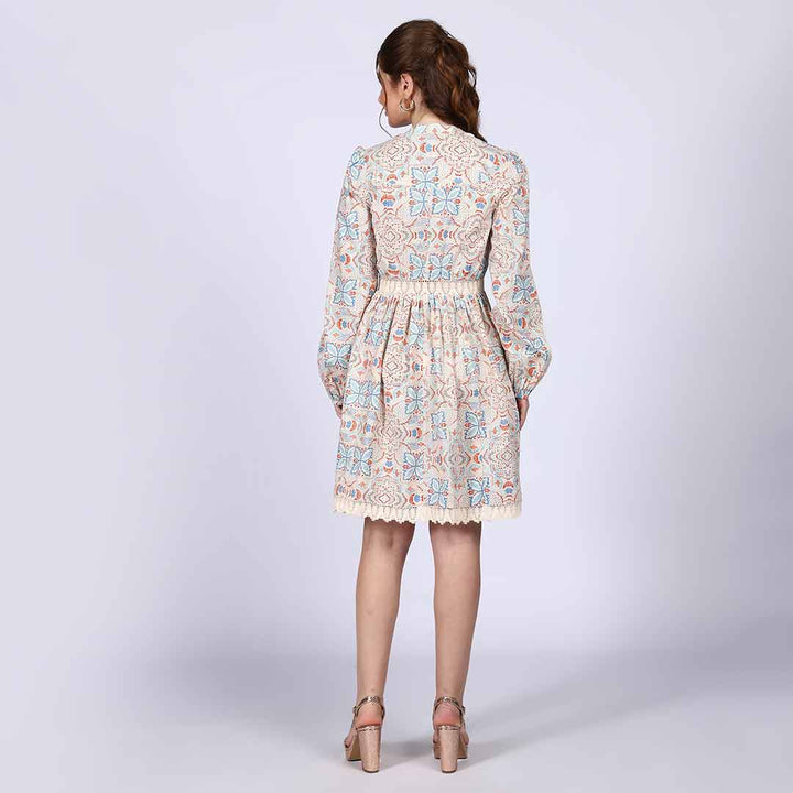 Back view of a woman wearing an ivory multicolour printed cotton dress.