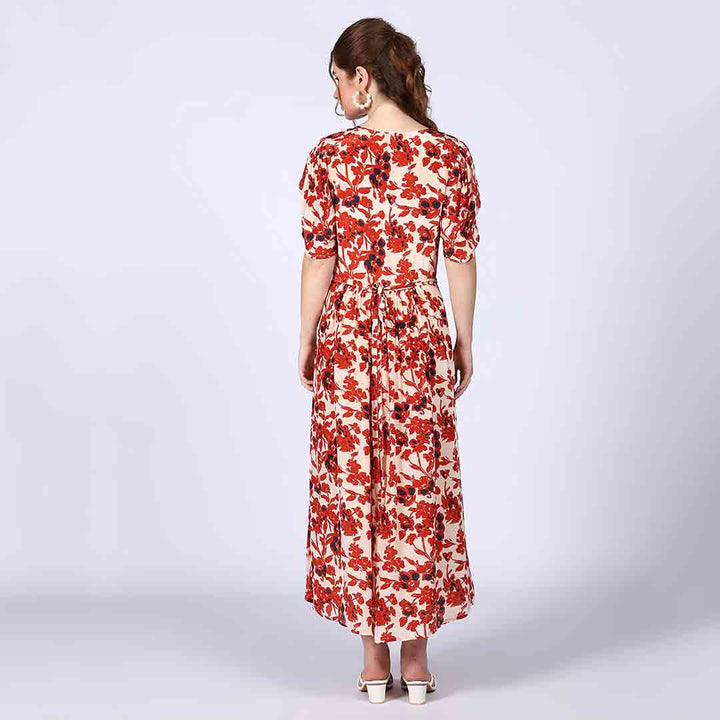 Full-length shot of a woman wearing an ivory red deep V-neck viscose dress.
