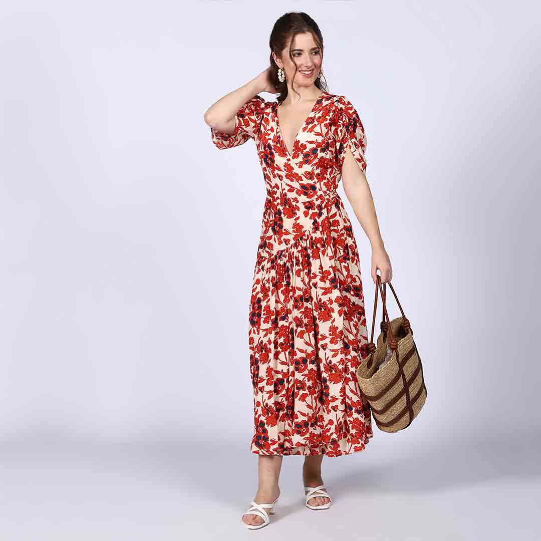 Side view of a woman wearing an ivory red deep V-neck viscose dress.