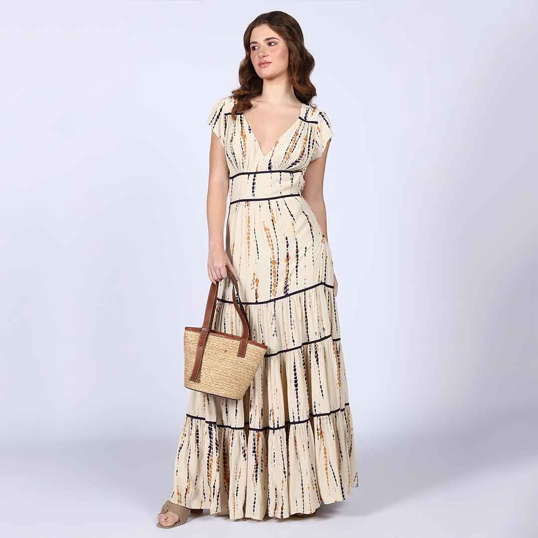 Close-up of the tie-dye print and tiered hem on an ivory viscose maxi dress.