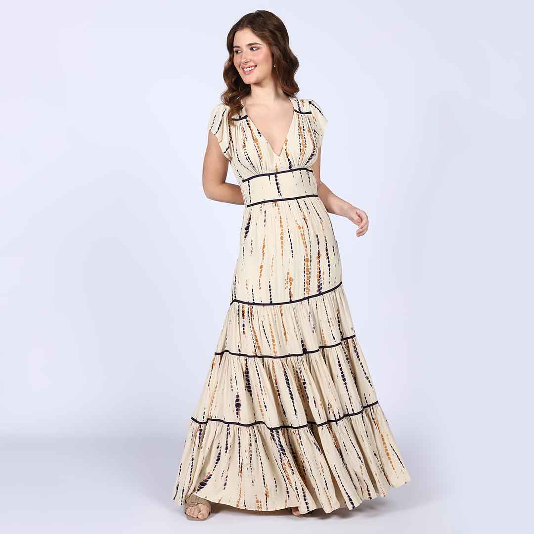 Woman wearing an ivory tie-dye-print tiered viscose maxi dress with a V-neck.