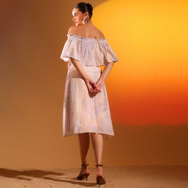 Full-length shot of a woman wearing a lilac midi dress, mid-calf length.