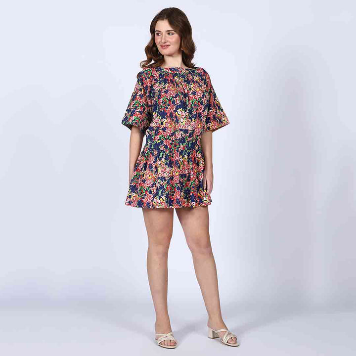 Alternate side view of a woman wearing a multicolour short dress.