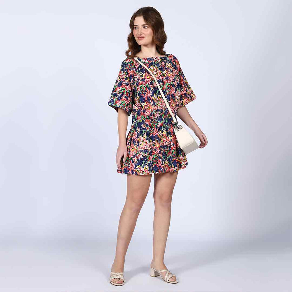 Side view of a woman wearing a multicolour floral-print short dress.