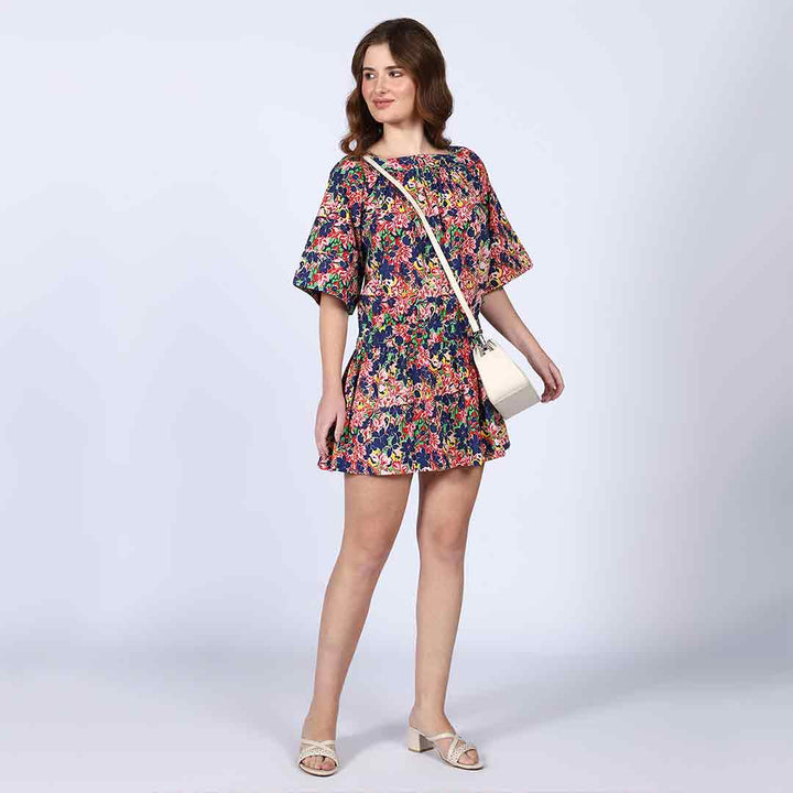 Side view of a woman wearing a multicolour floral-print short dress.