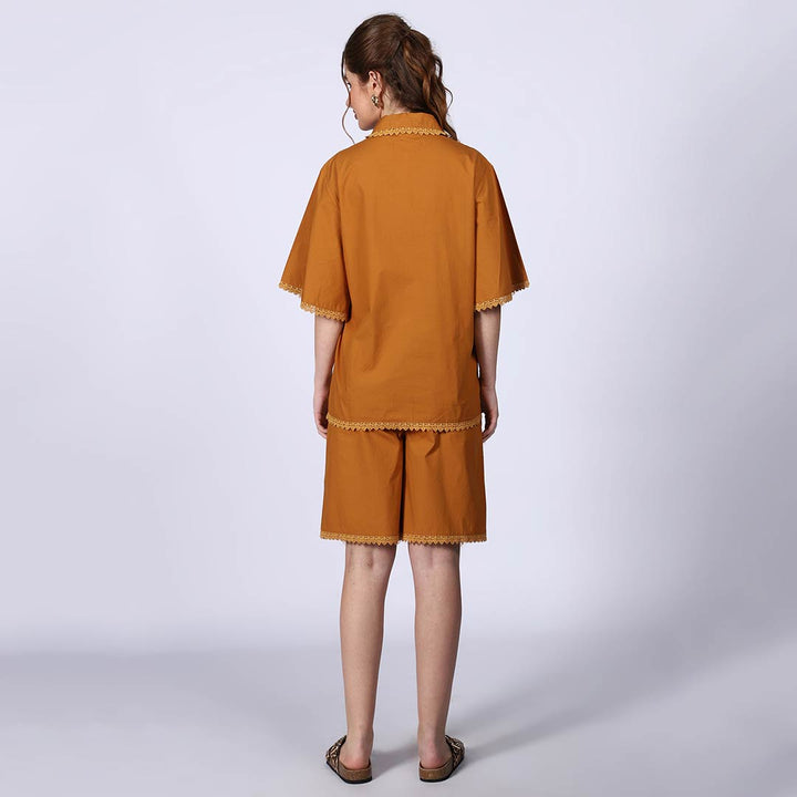 Back view of a woman wearing a mustard cotton poplin co-ord set.