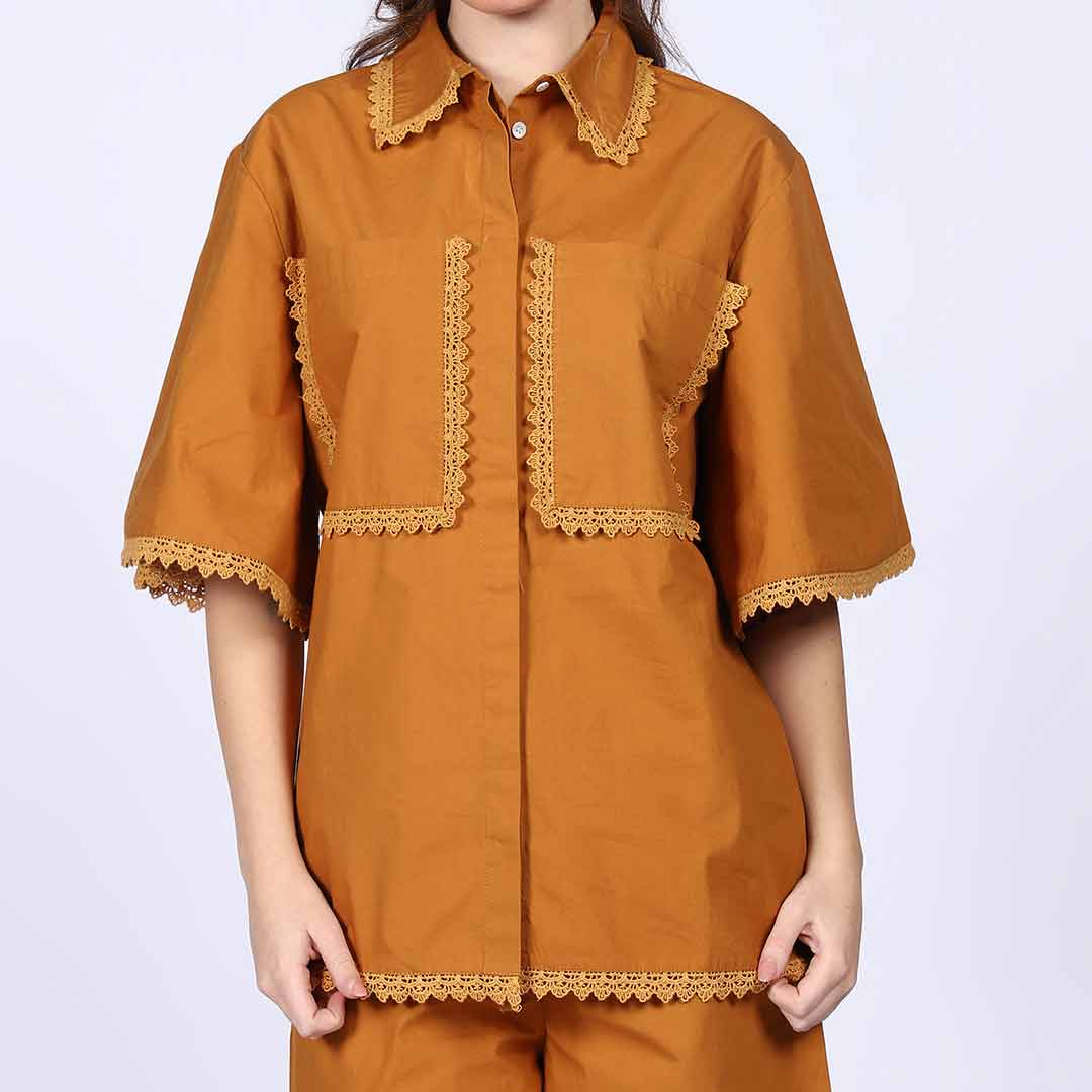 Close-up of the cropped top and shorts on a mustard cotton co-ord set.