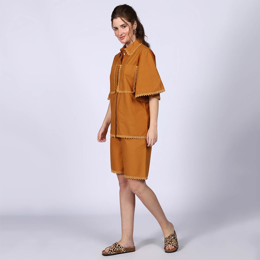 Full-length shot of a woman wearing a mustard cotton poplin co-ord set.