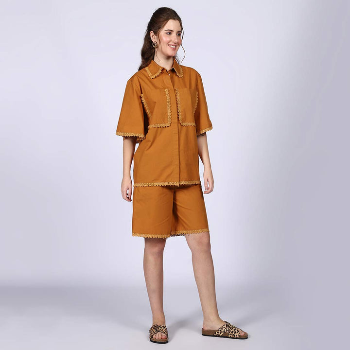 Side view of a woman wearing a mustard cotton co-ord set.