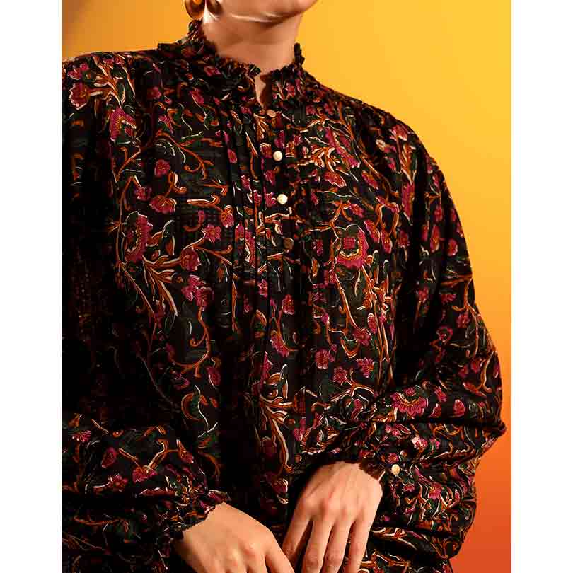 Close-up of the floral print and pintuck placket on an onyx dobby-weave top.