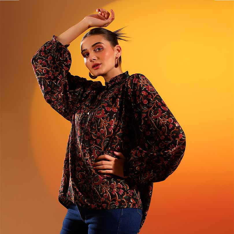 Side view of a woman wearing a multicolour floral-print onyx top.