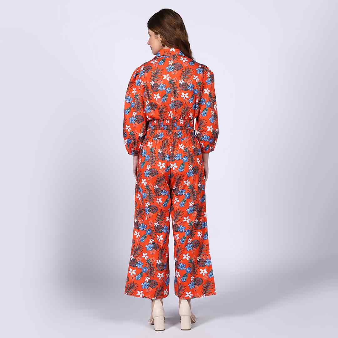 Back view of a woman wearing an orange floral co-ord set.