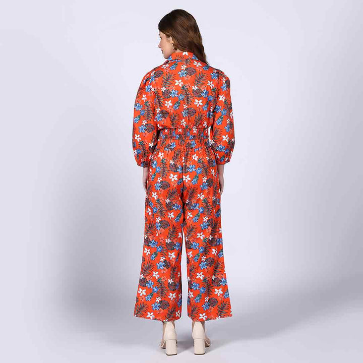 Back view of a woman wearing an orange floral co-ord set.
