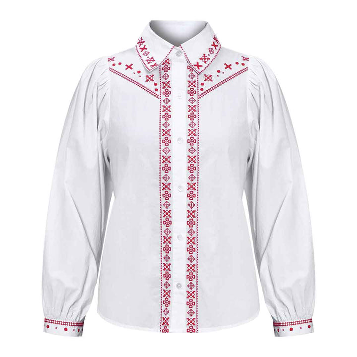 White cotton shirt with red cross-stitch embroidery on the collar, placket and cuffs, shown flat.