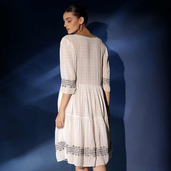 Women's white check dobby knee-length dress by Saint Wynona, back view showing tiered skirt.