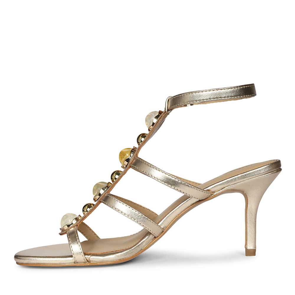 Saint Xiomara Gold Metallic Gem T-Strap Stiletto Heels, angled view