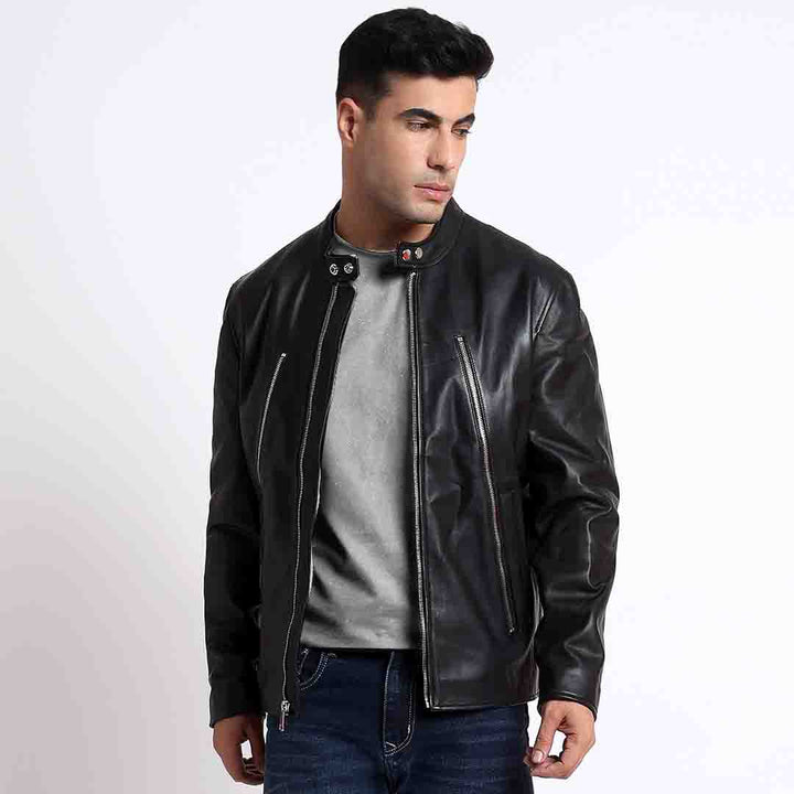 Man wearing an open black leather cafe racer jacket with a snap collar.