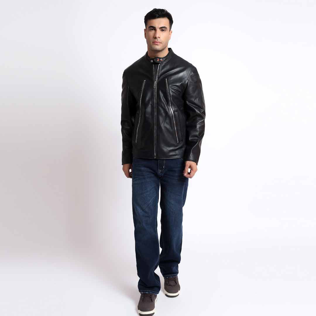 Full-length shot of a man wearing a black leather cafe racer jacket.