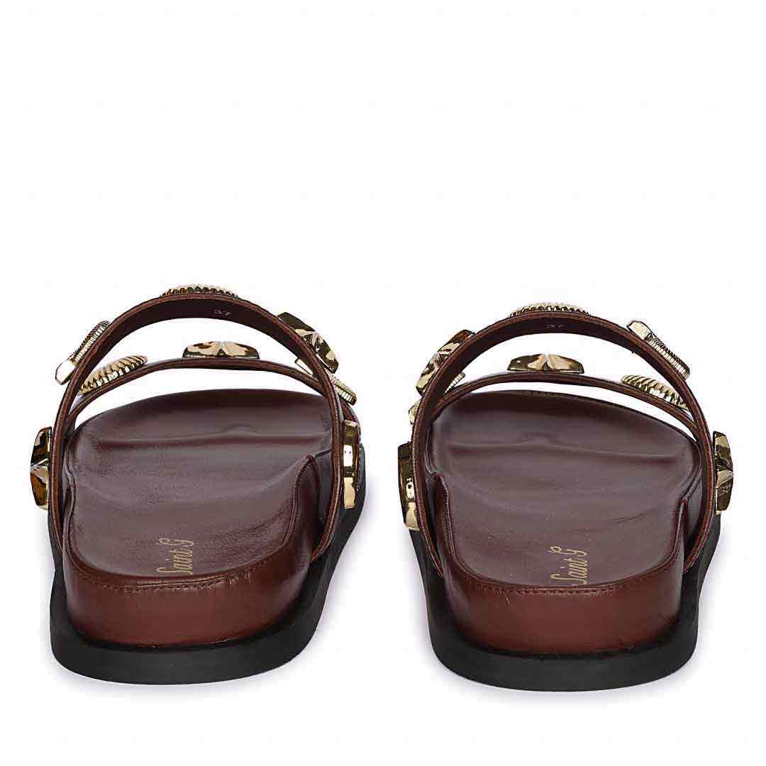 Pair of brown sandals with decorative straps on a white background - Back View