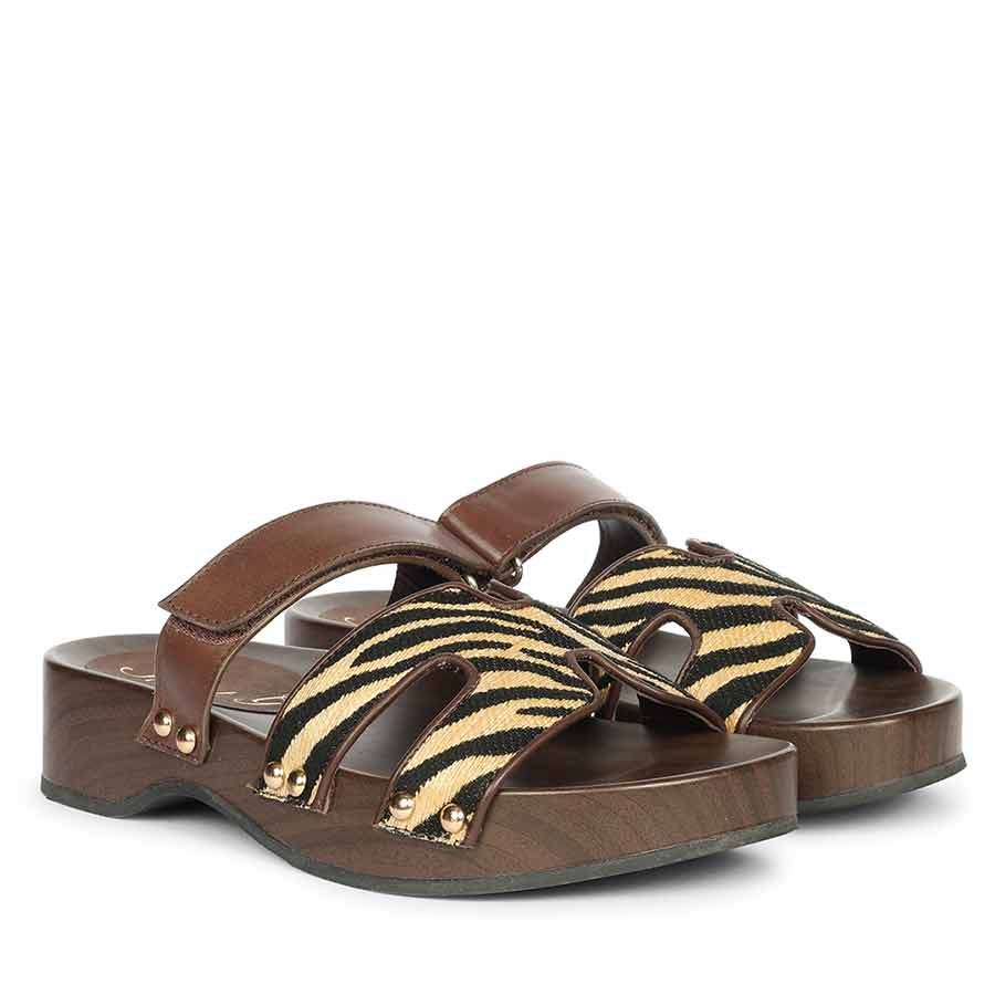 Womens Brown sandals with zebra pattern straps on a white background - Angled Pair