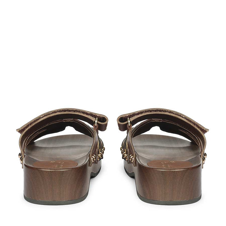 Pair of brown sandals on a white background - back
