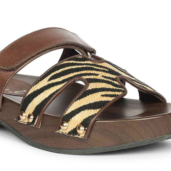 Brown sandal with zebra pattern strap on a white background- detail