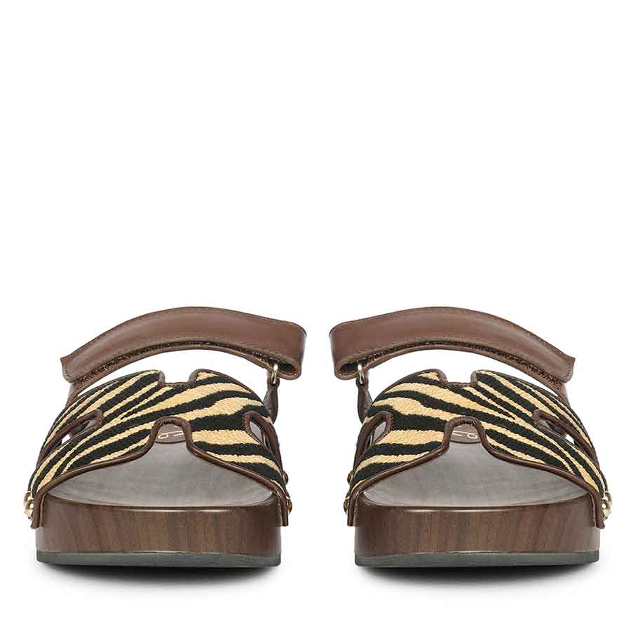 Pair of sandals with zebra pattern straps on a white background - Front