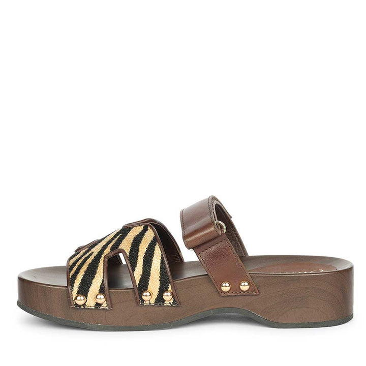 Womens Brown sandal with zebra pattern strap on a white background - side