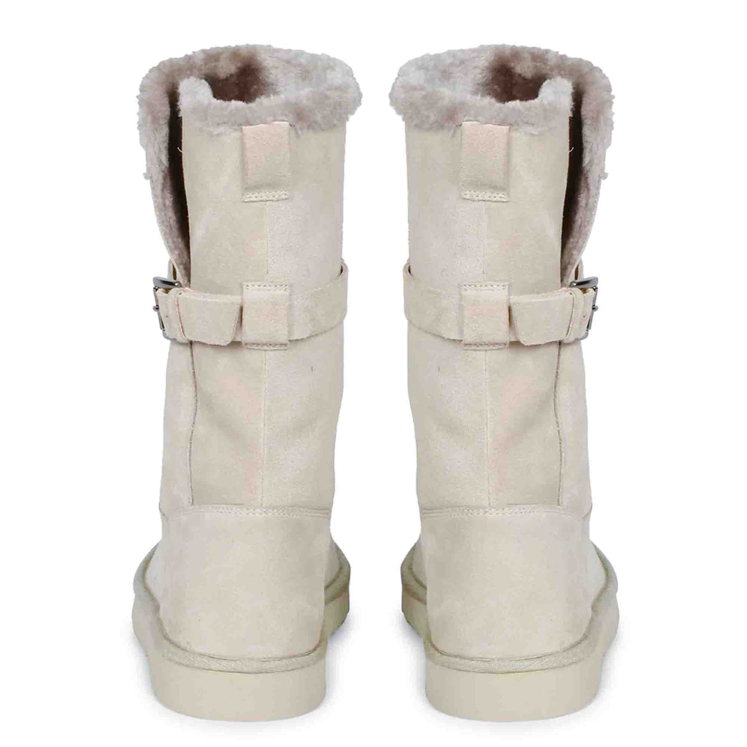 Chic ivory suede boots with decorative buckle, crafted by Saint Aurelia for snug comfort and style