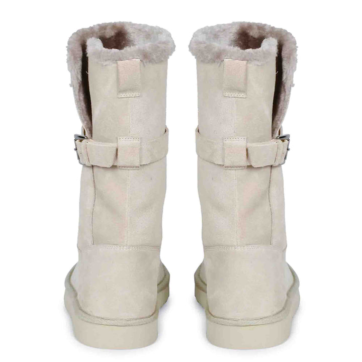 Chic ivory suede boots with decorative buckle, crafted by Saint Aurelia for snug comfort and style