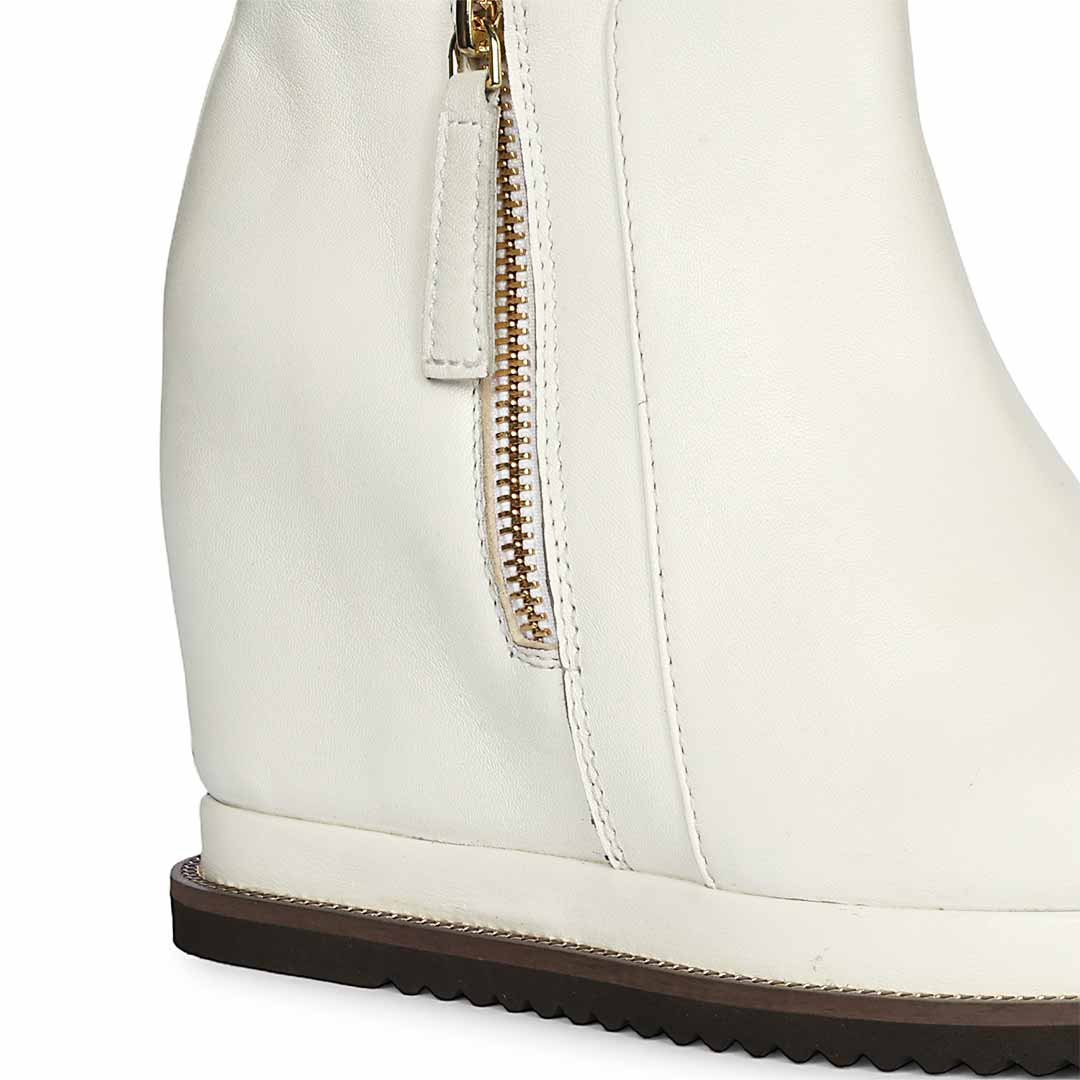 White leather wedge ankle boots for women with side zip, close side view
