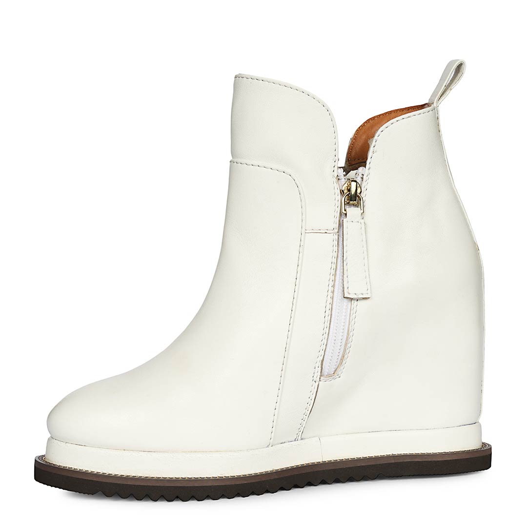 White leather wedge ankle boots for women with high inside wedge, side profile