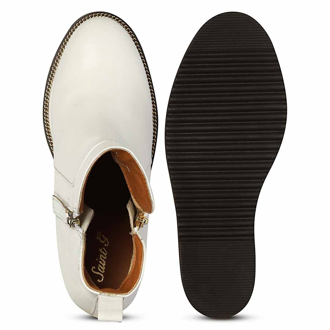 Sole and inside wedge of womens white leather ankle boots
