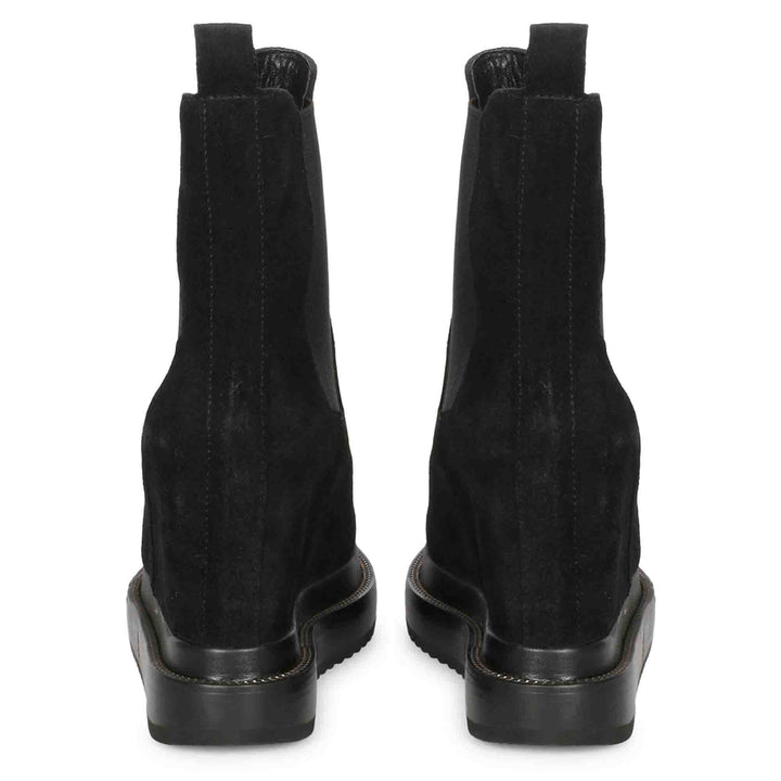 Pair of ladies black wedge ankle boots, back view