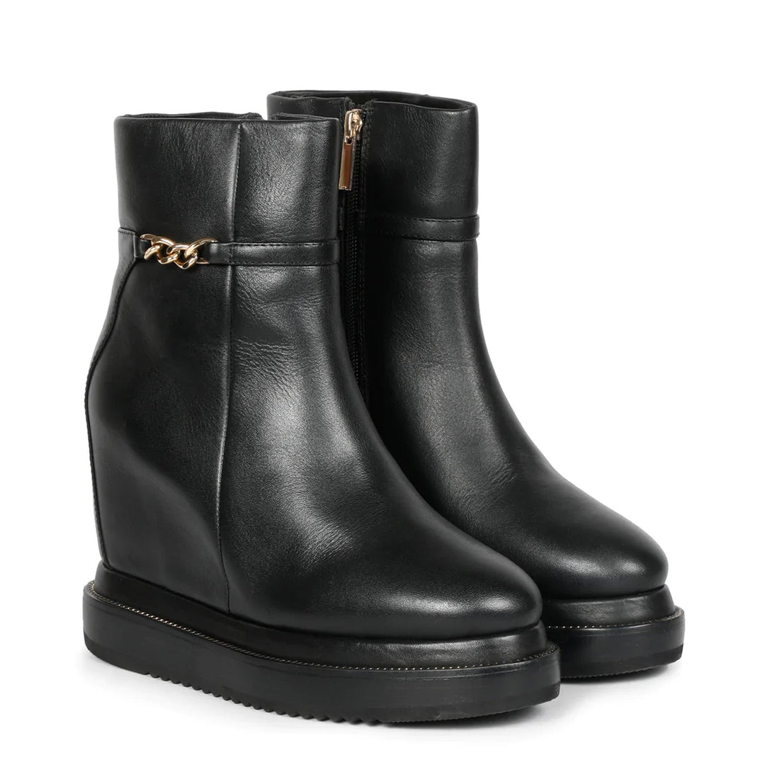 Black leather wedge ankle boots for women with gold zip, angled view