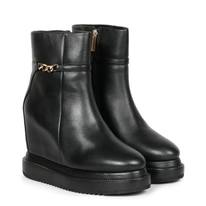 Black leather wedge ankle boots for women with gold zip, angled view