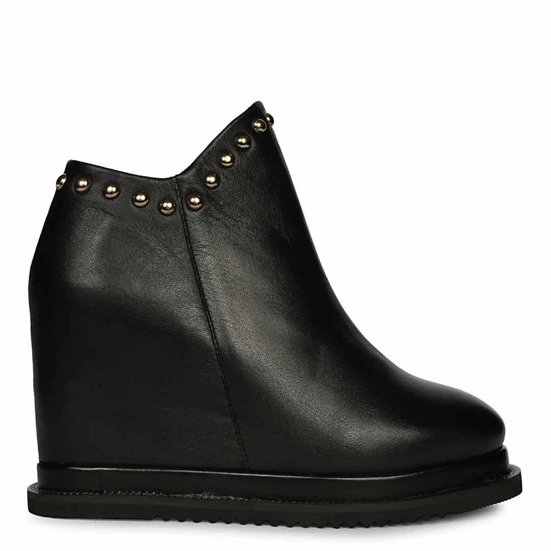 Womens black studded leather wedge ankle boots, side view