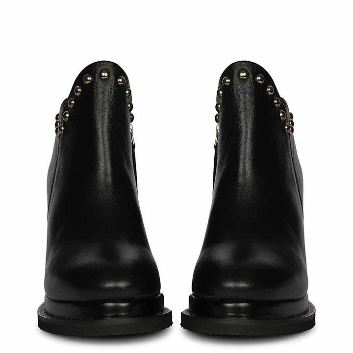 Pair of womens black studded leather wedge ankle boots, front view